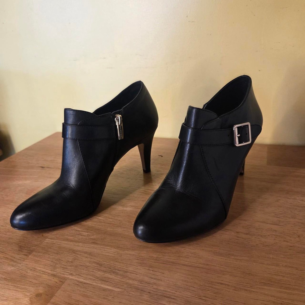 Vince Camuto black leather ankle boots with gold buckle and zipper